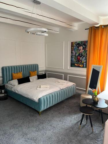 a bedroom with a large bed with a blue couch at Boutique Hotel Pošta RL in Oravský Podzámok