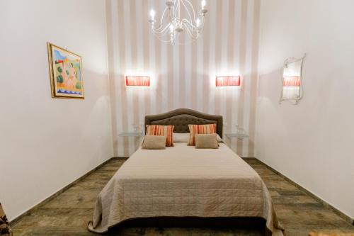 a bedroom with a large bed with two pillows at Residenza Carlandi Tivoli in Tivoli