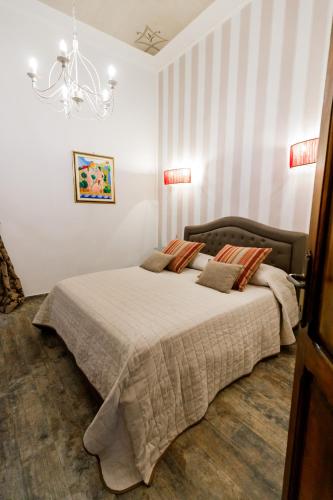 a bedroom with a bed and a chandelier at Residenza Carlandi Tivoli in Tivoli