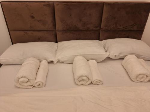 a bunch of towels on a bed with pillows at RIVIJERA CITY in Belgrade