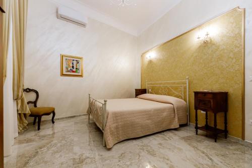 a bedroom with a bed and a table and a chair at Residenza Carlandi Tivoli in Tivoli