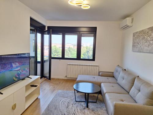 a living room with a couch and a tv at RIVIJERA CITY in Belgrade