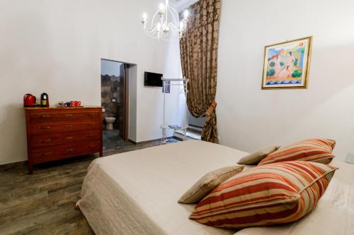 a bedroom with a bed and a dresser in it at Residenza Carlandi Tivoli in Tivoli