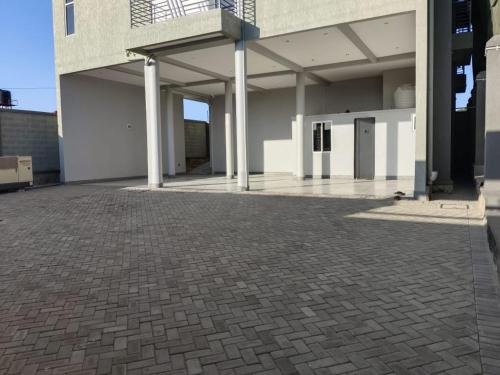 a large building with a brick parking lot at Winslow Luxury apartments with Wifi connection and a gorgeous Lake sunset view in Kampala