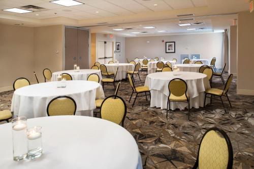 a room filled with tables and chairs with white table cloths at Hilton Garden Inn St. Louis/Chesterfield in Chesterfield
