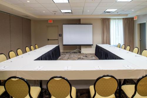a large conference room with a large table and chairs at Hilton Garden Inn St. Louis/Chesterfield in Chesterfield