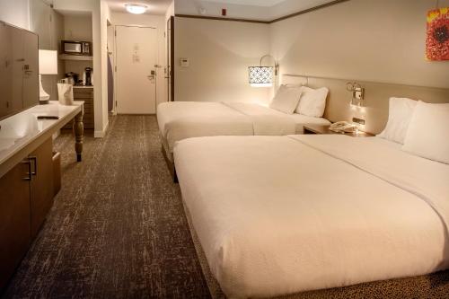 a hotel room with two beds and a kitchen at Hilton Garden Inn St. Louis/Chesterfield in Chesterfield