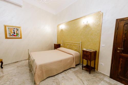 a small bedroom with a bed and a wooden cabinet at Residenza Carlandi Tivoli in Tivoli