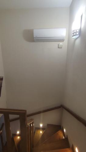 a room with a staircase with a air conditioner on the wall at Modern Sea Villa in Leptokaria in Leptokaria