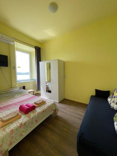 a hotel room with a bed and a window at Dejan apartment 3-Free parking near Arena in city center, near bus, train, ferry, airport shuttle in Pula