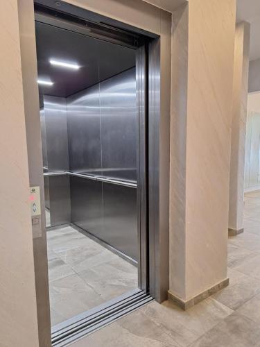a sliding glass door in a walk in closet at RIVIJERA CITY in Belgrade