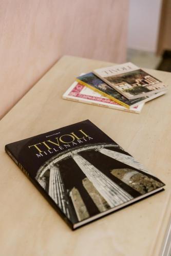 a book on a table with magazines on it at Residenza Carlandi Tivoli in Tivoli