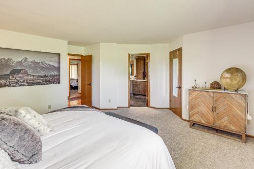 a bedroom with a white bed and a wooden dresser at Charming Joliet Ranch House on a Working Farm in Silesia