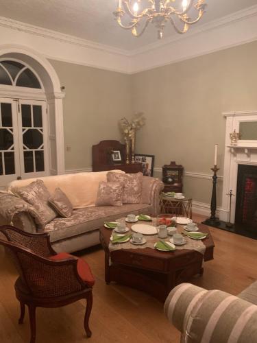 a living room with a couch and a coffee table at Lisglassock House in Longford