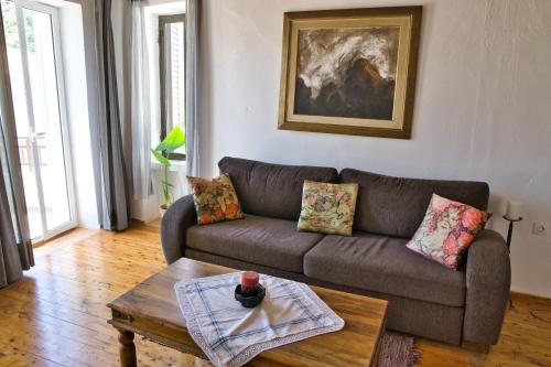 a living room with a couch and a coffee table at Velanidia Homestay in Velanídhia