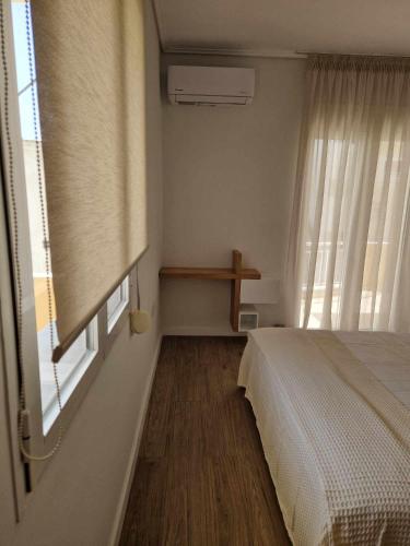 a bedroom with a bed and a window at Mitilini's Luxury Home in Mytilini