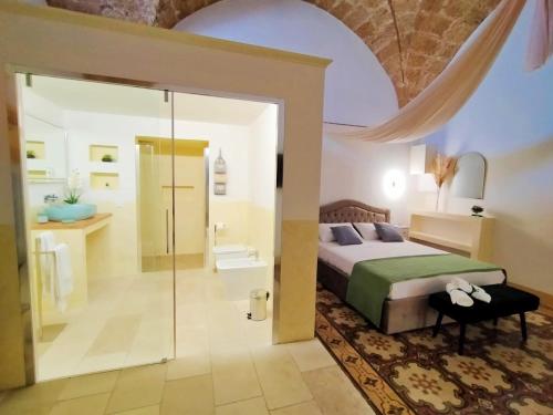 a bedroom with a king sized bed and a bathroom at Suite Le Marie Room & Relax in Barbarano