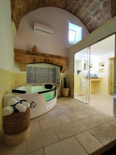 a bathroom with a tub in the middle of a room at Suite Le Marie Room & Relax in Barbarano
