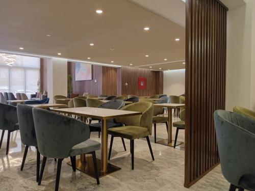 a waiting room with tables and chairs in a building at Executive Boutique Hotel Rabat in Rabat