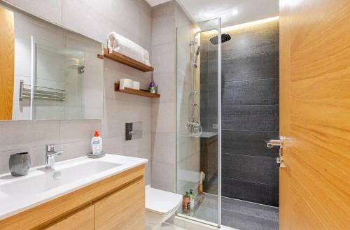 a bathroom with a shower with a sink and a toilet at Atlantic Suite View 1 in Casablanca