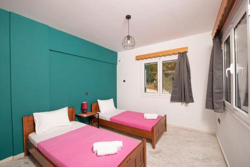 a room with two beds and a window at Elena Studios in Athanion