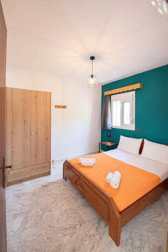a bedroom with a large bed with two towels on it at Elena Studios in Athanion
