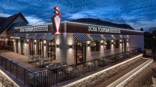 a rendering of the exterior of a restaurant at night at Sheraton Westport Plaza in Maryland Heights