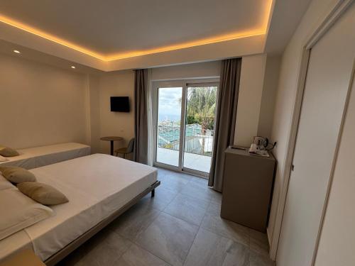 a bedroom with a bed and a view of a balcony at Villa Mimosa Florital - Free Private Parking On site & in Tropea in Santa Domenica