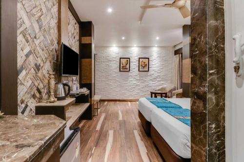 a hotel room with a bed and a bathroom at Hotel ACME in Kolkata