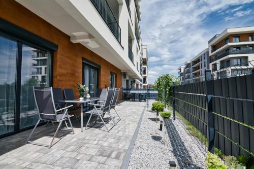 a patio with chairs and a table on a building at Pankrac 2 by Housine in Zator