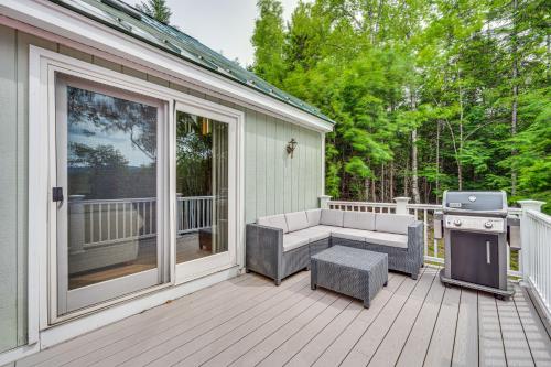 a screened in porch with a bench and a grill at Campton Home with Mountain Views Near Trails and Lake in Campton
