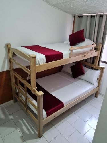 a pair of bunk beds in a room at Hotel Don Juan Colonial in Floridablanca