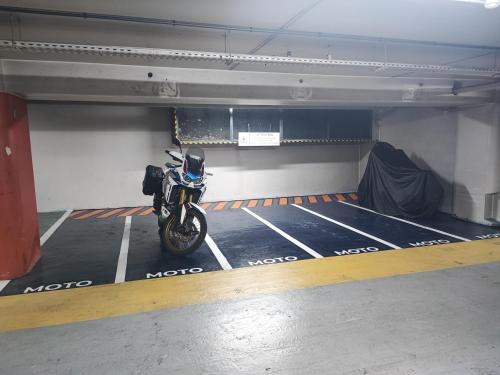 a motorcycle parked in a parking garage at Studio en Duplex-Aircon-Terrasse-Parking-Calme in Bordeaux