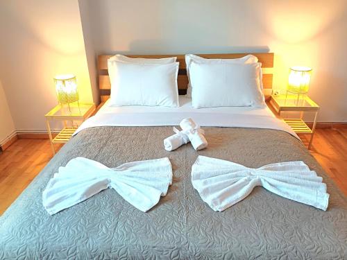 a bed with two bow ties on it at Angela's Apartment in Chalkida