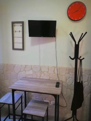 a room with a table and a clock on the wall at CH Guest Rooms in Vernole