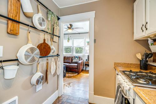 a kitchen with dishes hanging on the wall at Deck and Fire Pit Manitou Mountain Retreat in Manitou Springs