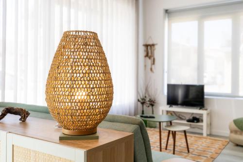 a living room with a lamp on a table at Casa na Areia in Leiria