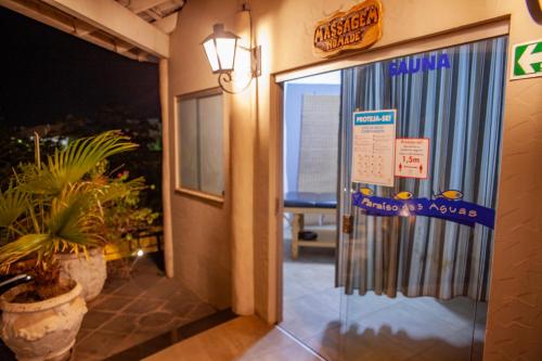 an entrance to an office with a glass door at VOA Hotel Paraíso das Águas Bonito in Bonito