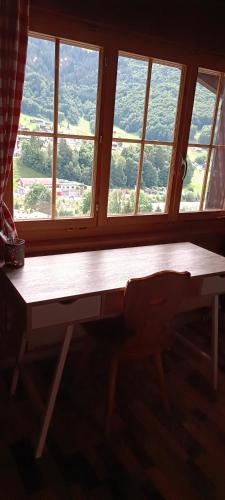 a table in front of a window with a view at Haldi Apartment in Klosters Serneus