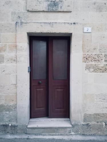 a wooden door in a stone building with at CH Guest Rooms in Vernole