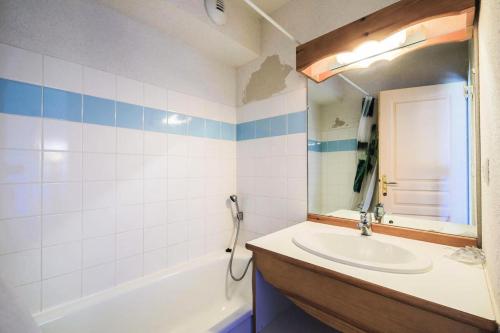 une salle de bain avec un lavabo, une baignoire et un miroir dans l'établissement Résidence La Crête du Berger - maeva Home - Appartement 2 pièces 6 personnes - Confort MAE-1754, à Agnières-en-Dévoluy