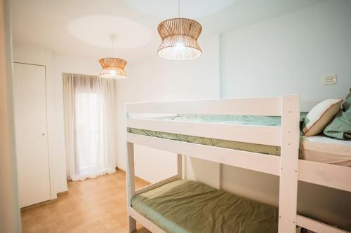 a bedroom with two bunk beds and two lights at Ondas do Mar Boutique Stays - Portonovo 3 in Portonovo