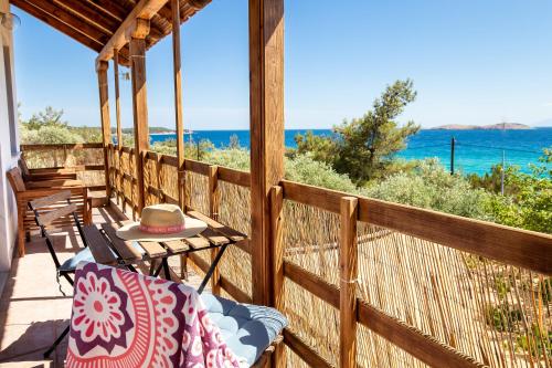 a porch with a table and chairs and the ocean at Emilia's House in Astris