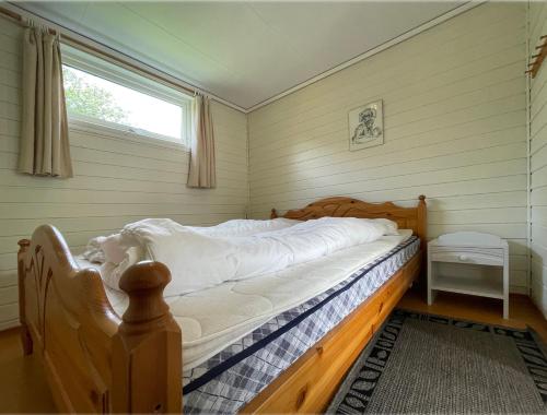 a bed in a room with a window at Hytte Nr 2 in Selje