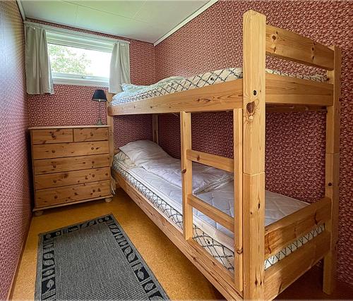 a bedroom with two bunk beds and a window at Hytte Nr 2 in Selje
