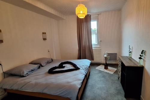 une chambre avec un lit, une commode et une fenêtre dans l'établissement ginalia cottage, à Éclaron