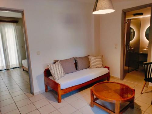 a living room with a couch and a table at Nancy - Chara Apartments in Karteros