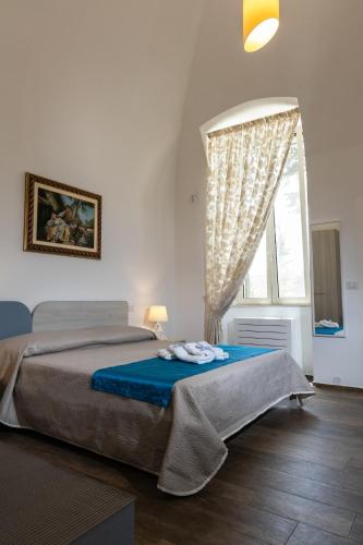 a bedroom with a bed and a window at Villa Ramona in Noicattaro