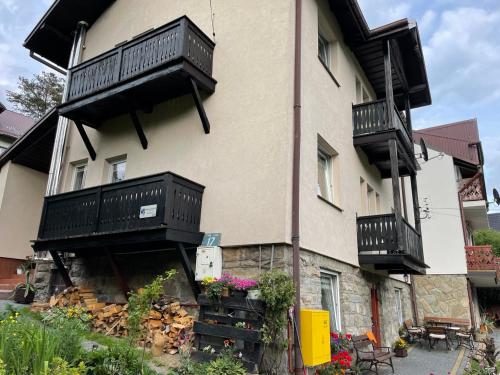 a building with balconies on the side of it at Szczawnica - Pokoje z widokiem na góry in Szczawnica