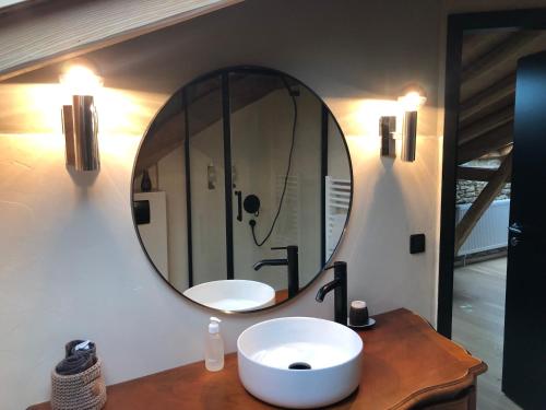 a bathroom with a sink and a mirror on the wall at la maison d'Obinat in Auzas